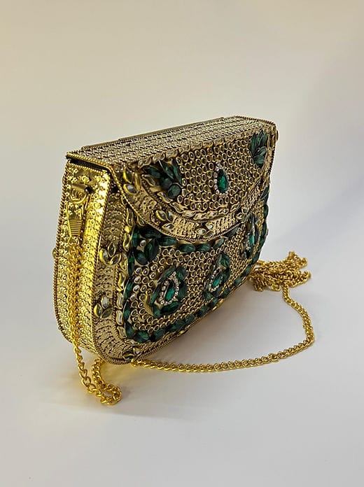 Luxury handcrafted Jadau work brass clutch styled with ethnic Indian fashion