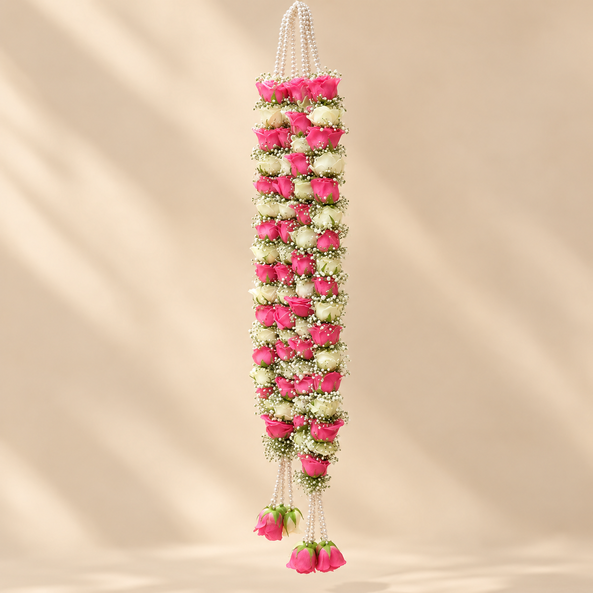 Pearl string tassels and pink rose buds on a pink and white dulha dulhan wedding mala