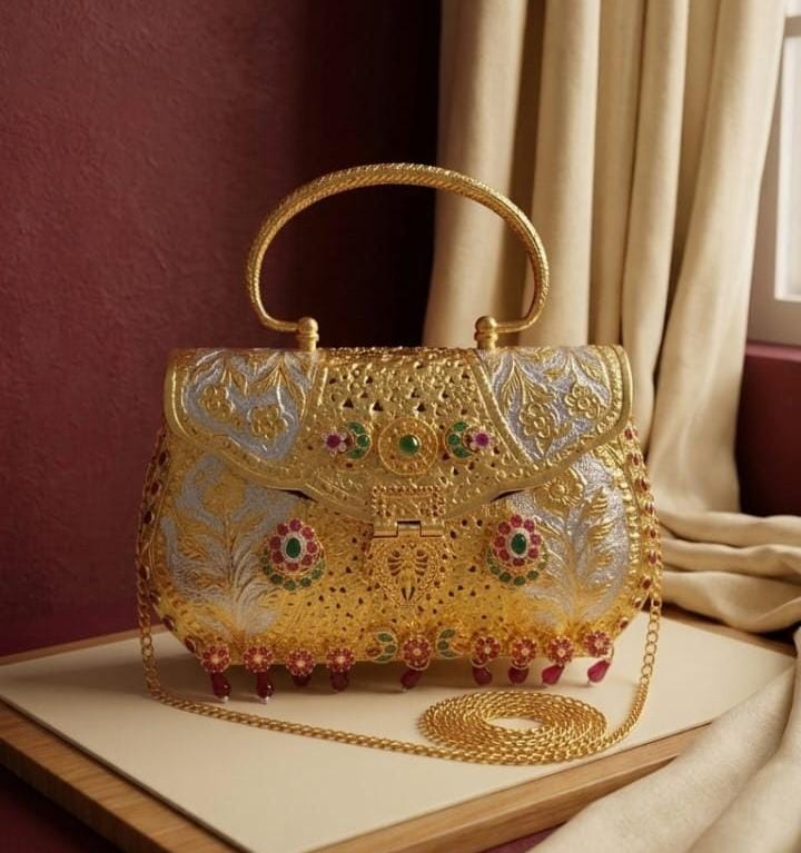 Handcrafted royal bridal purse with dual-tone gold and silver finish, intricate Pachi Kundan-style floral embellishments, decorative hanging beads, top handle and gold sling chain.