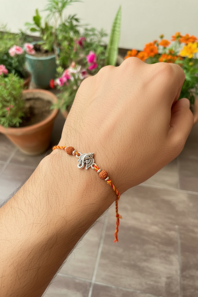 Traditional silver Ganpati Rakhi with Rudraksha beads for Raksha Bandhan