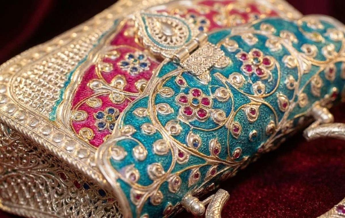 Decorative metal handle and structured silhouette of an antique oxidised brass ethnic clutch bag