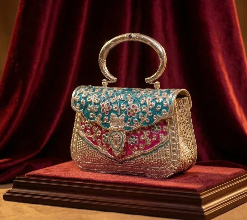 Antique oxidised brass clutch bag with blue and pink Meenakari and red-stone Parchi Kundan work