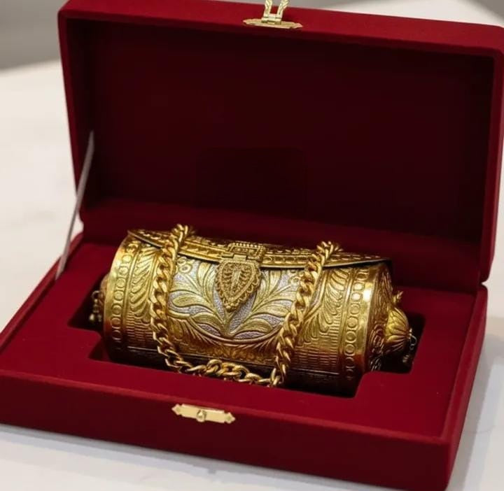 Close-up of double-tone brass gold clutch with antique detailing