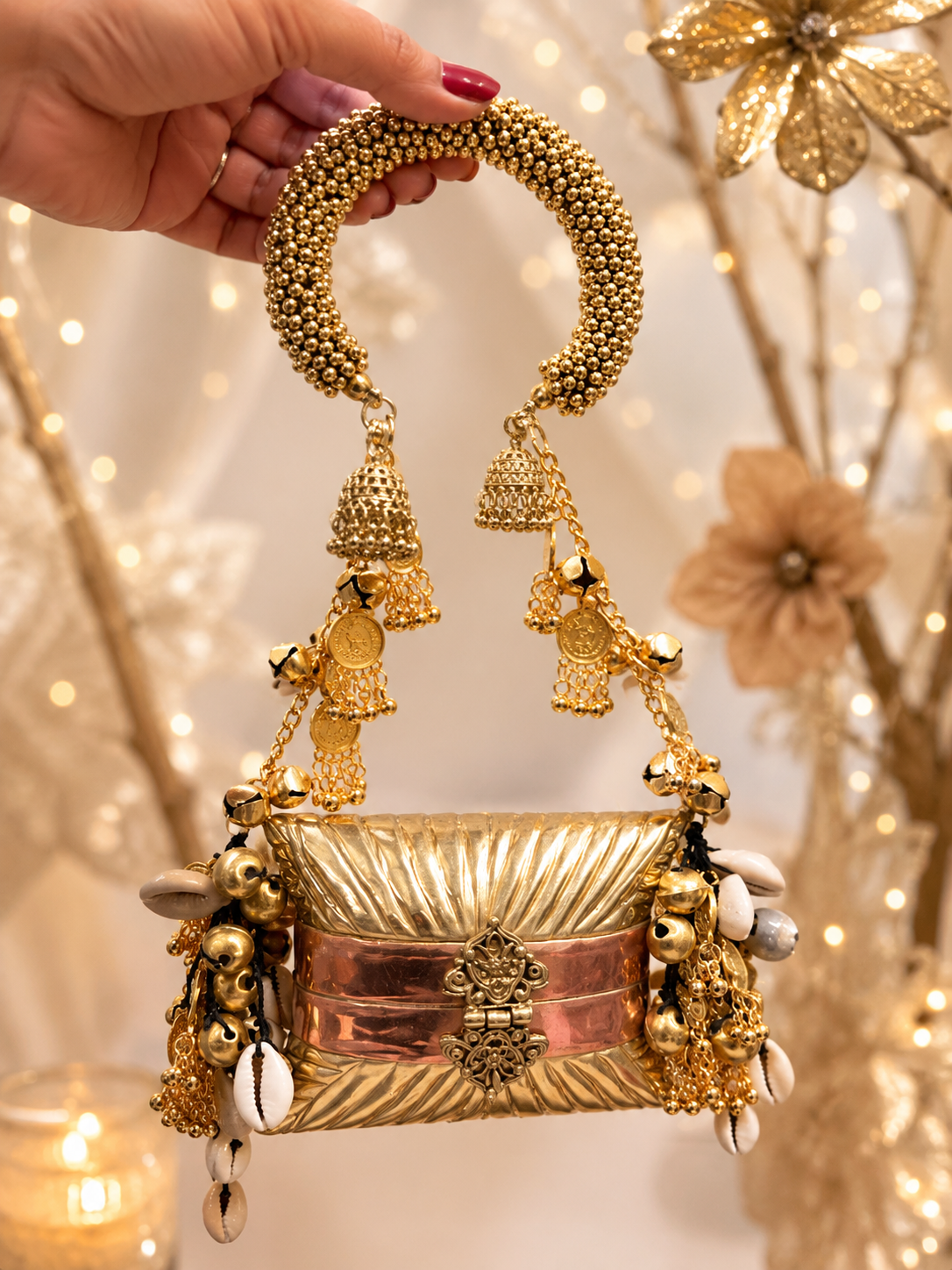 Designer handcrafted metal clutch with beaded handle, ghungroo and shell detailing