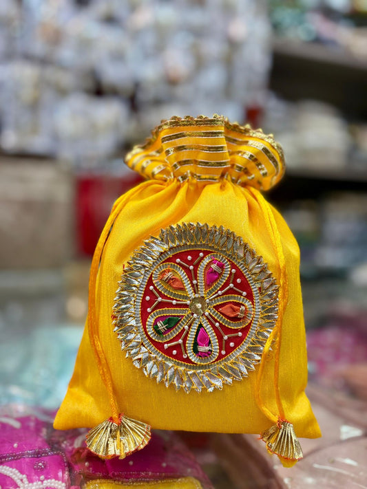Handcrafted Dupion silk sagun potli bags in a pack of six for traditional Indian gifting.