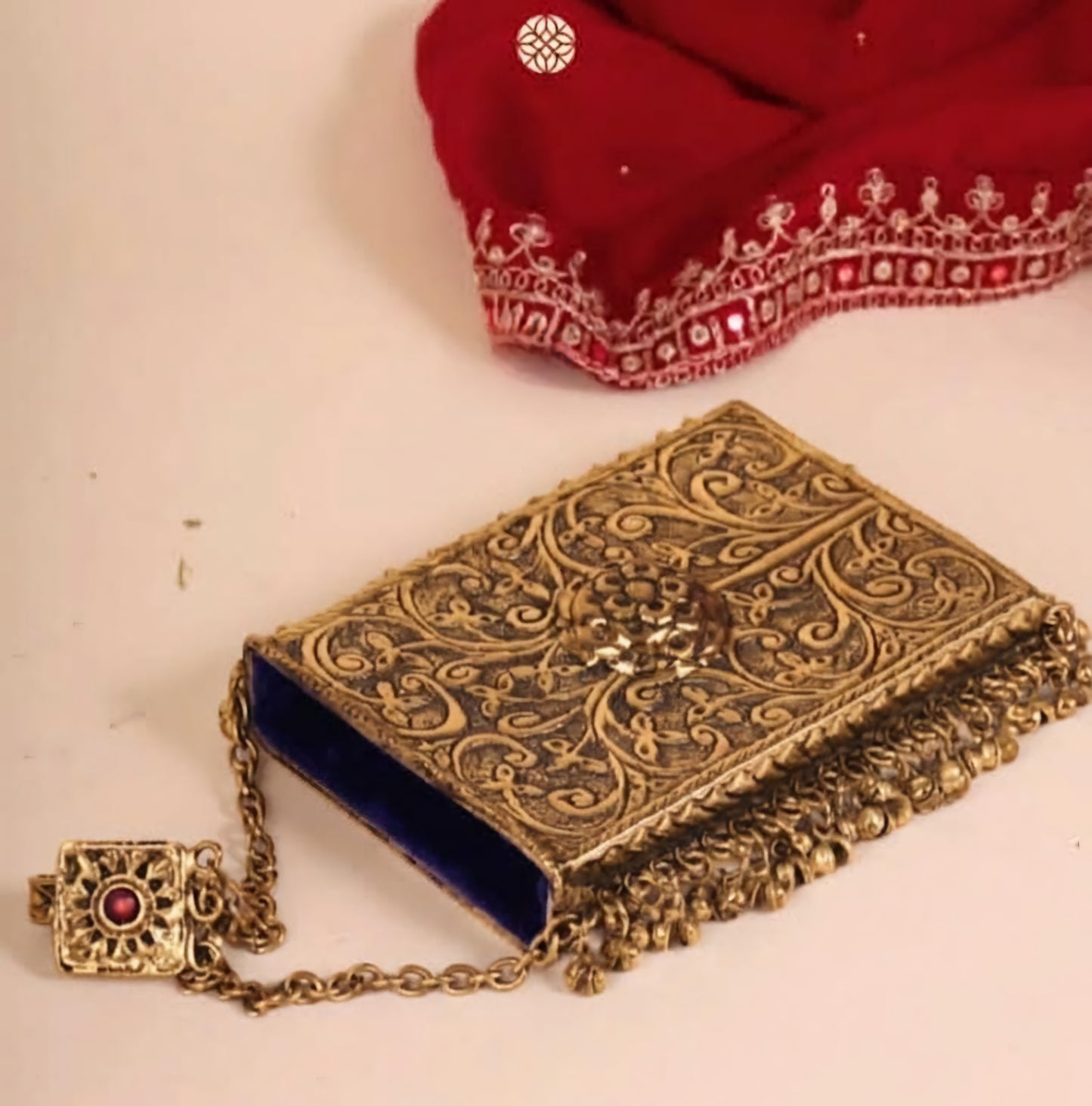 Brass designer clutch featuring traditional Ghoongroo and Meena detailing
