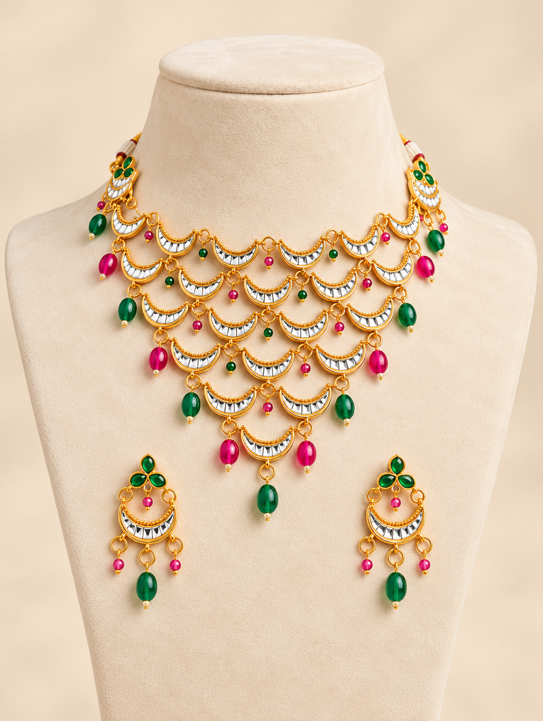 Traditional gold-tone layered crescent necklace set with emerald green bead drops and matching earrings for Indian ethnic wear