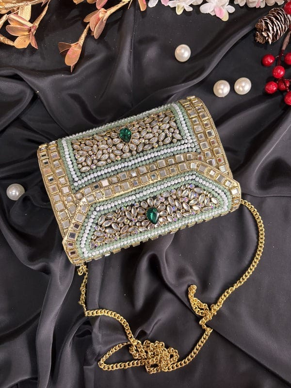 Close-up of intricate Jadau work on handcrafted brass metal clutch