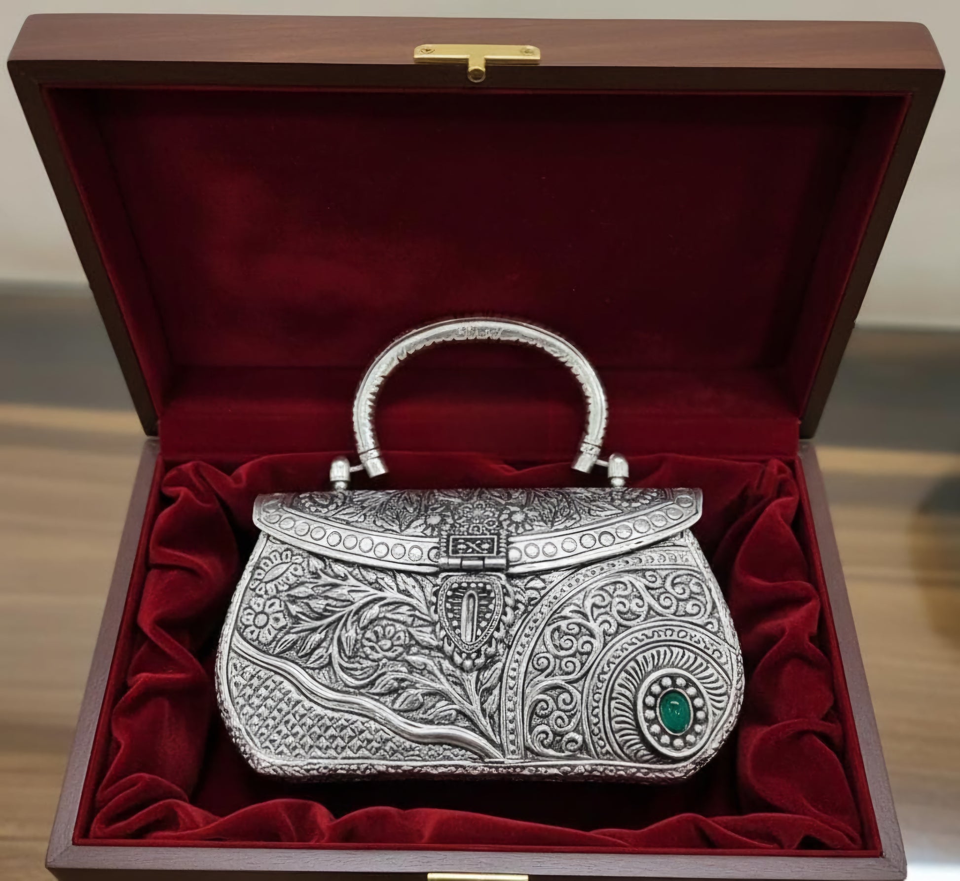 Kundan-inspired detailing on a traditional brass metal clutch