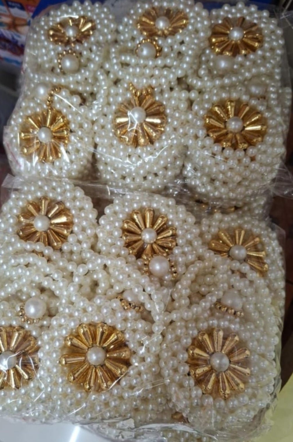 Close-up of pearl-style moti beadwork on a decorative coin pouch