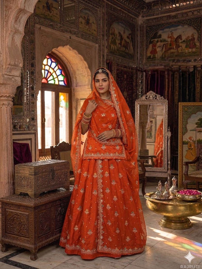 Orange designer Rajputi poshak with Kasab Zari handwork