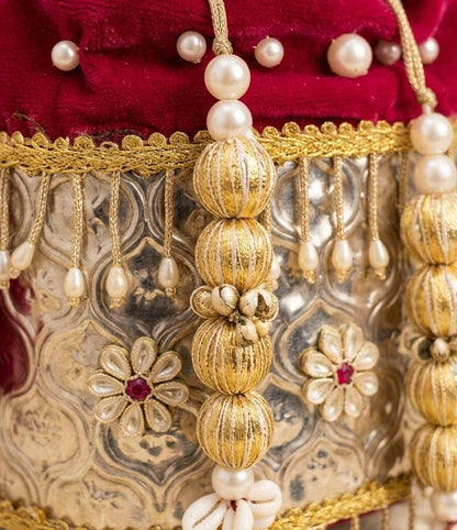 Pink velvet metal potli sling bag with traditional gold detailing