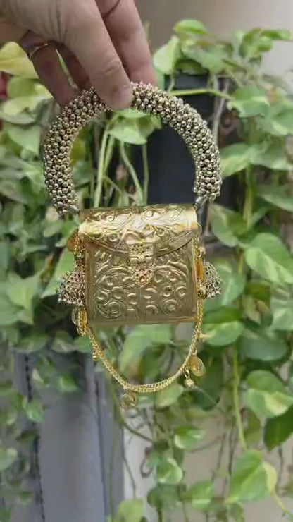 Golden Banjara mini metal purse with a long sling chain for carrying cash and small essentials