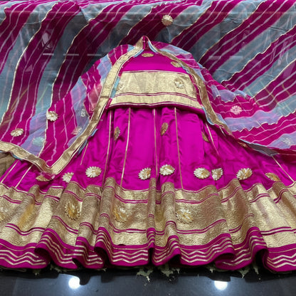 Rajasthani woman wearing Rajputi Lehriya satin suit with Pure Odhni