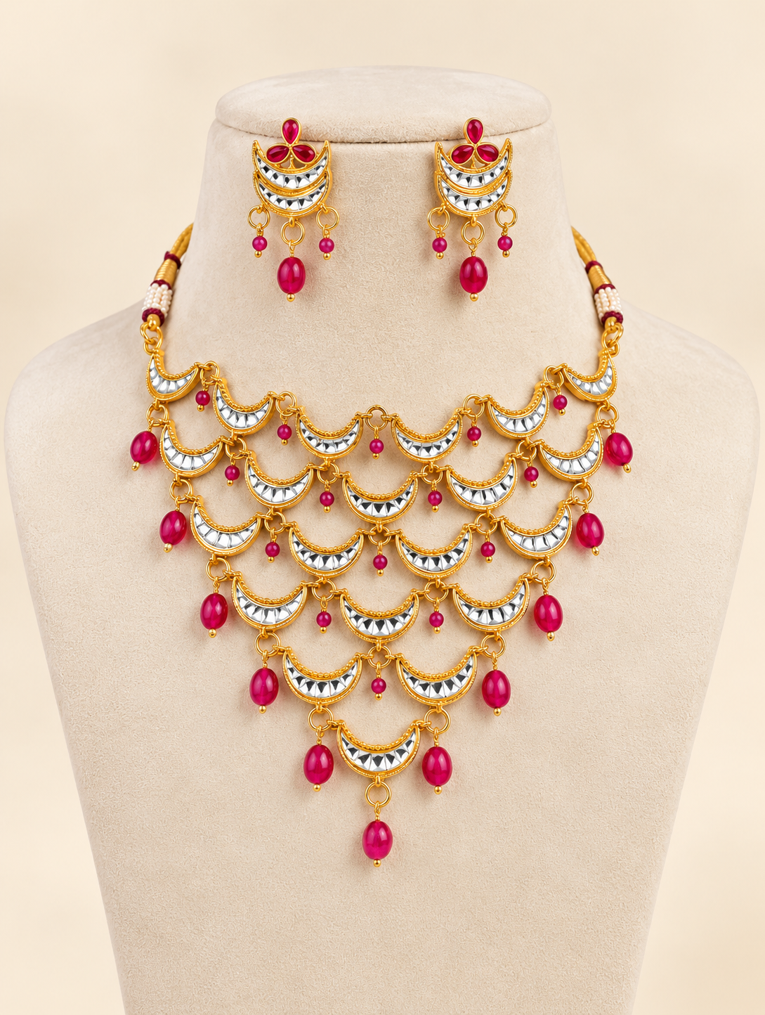 Traditional gold-tone crescent necklace set with rani pink bead drops and matching earrings for wedding and festive wear