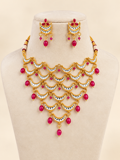 Traditional gold-tone crescent necklace set with rani pink bead drops and matching earrings for wedding and festive wear