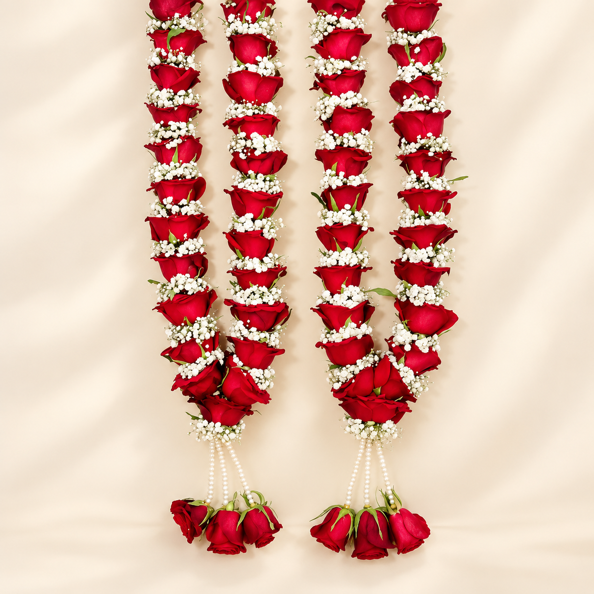 Red rose and white floral varmala pair for bride and groom with pearl-style hanging strands and rose tassels