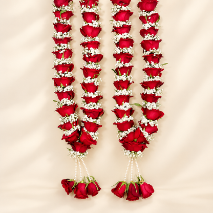 Red rose and white floral varmala pair for bride and groom with pearl-style hanging strands and rose tassels