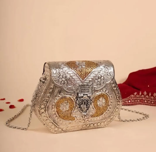Royal Heritage dual tone brass clutch bag with intricate ethnic detailing