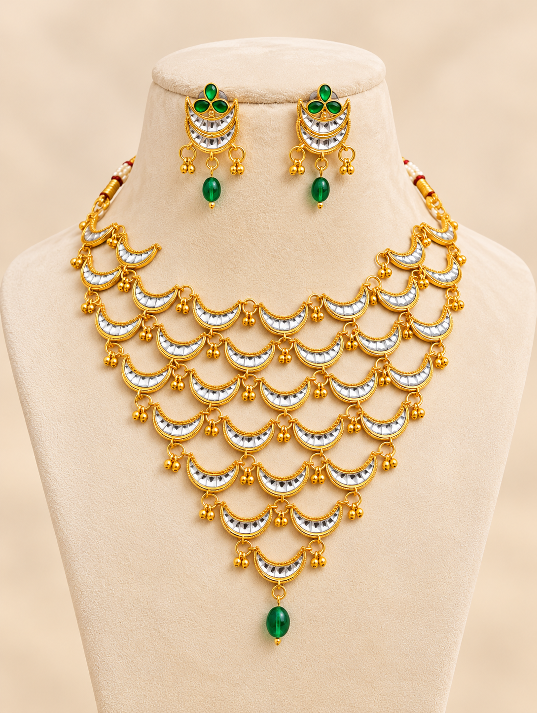 Traditional gold-tone layered necklace set with ruby red bead drops and matching earrings for Indian weddings and ethnic outfits