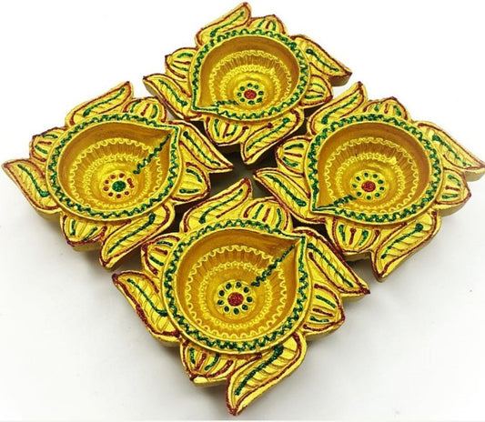 Set of four terracotta clay diyas featuring a traditional Swastik design