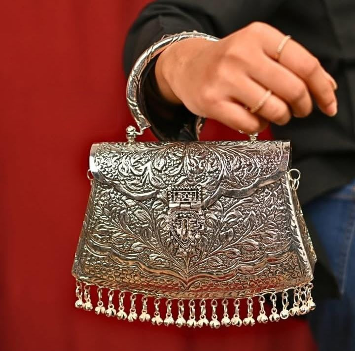 Vintage silver brass ethnic clutch styled for a wedding occasion