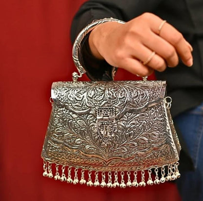 Vintage silver brass ethnic clutch styled for a wedding occasion