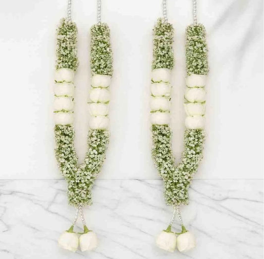 White and green floral varmala pair for bride and groom with white flower sections and hanging floral ends